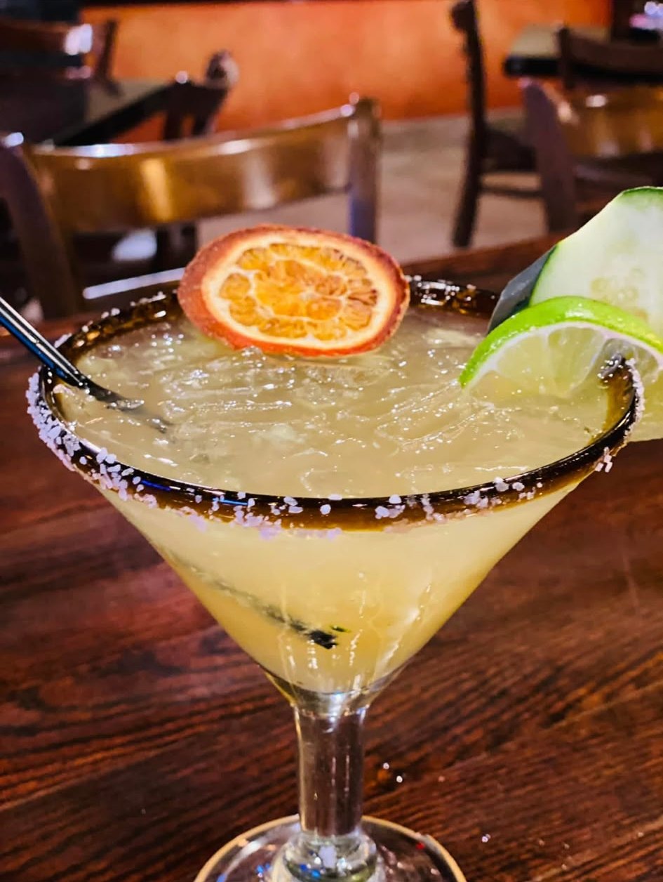 A house margarita with dried orange and salted rim at the Los Agaves bar