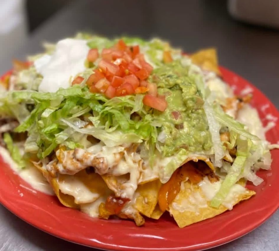 Loaded nachos with guacamole, sour cream and pico de gallo